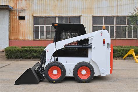 tipped skid steer|wheeled skid steer tipping load.